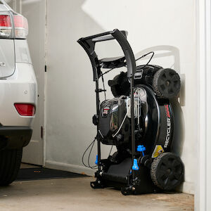 Mower placed against an inside wall of a garage in the
