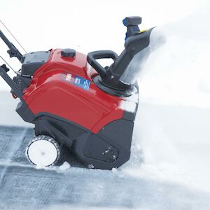 The Toro Clear 518 ZE single stage Snow Blower features an 18-inch clearing  width and a compact design with a fold-down handle and chute for easy  storage.