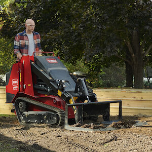 TX700 using the leveler attachment to level the pile of dirt
