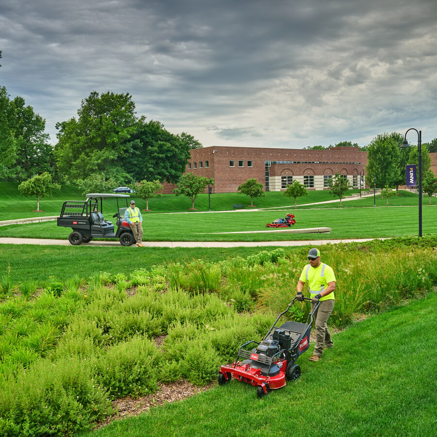 Toro Proline Autonomous Mower mowing with landscape contractors using other products on the lawn