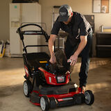 Pick your power - Man adding a battery to the mower