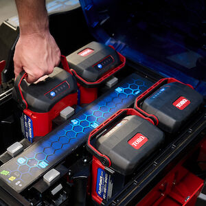 Image of person adding adding the 4th battery in a eTimeCutter mower