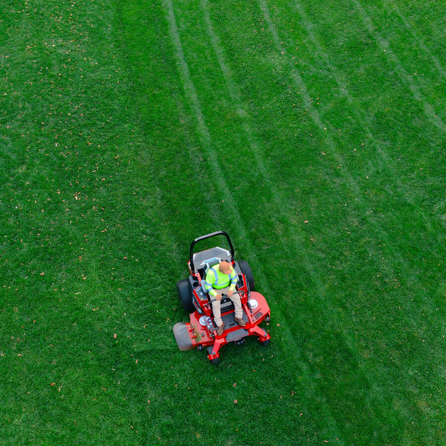 Z Master Revolution mower in use - mowing a lawn - view is from an aerial viewpoint - looking down on mower and lawn.