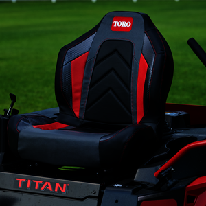 Close up image of the seat on the Titan Mower - seat is black with red side stripes