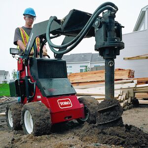 Dingo 320D wheeled digging holes using the auger attachment