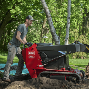 Man shown walking behind and pushing Dingo TX 550