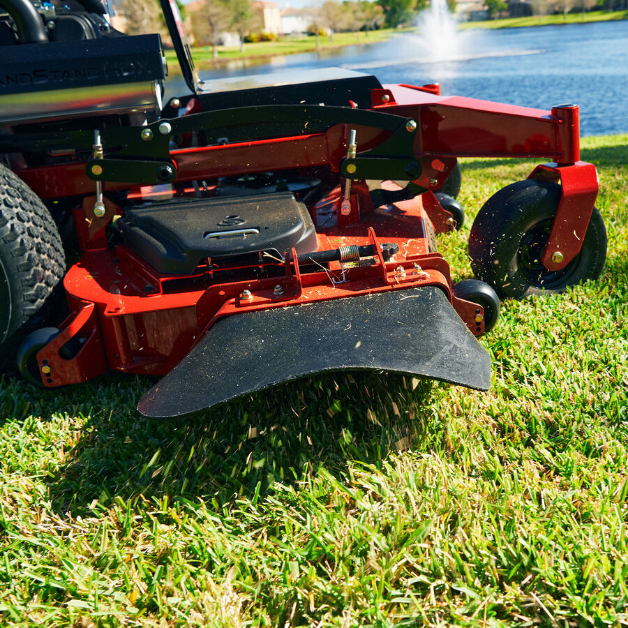 GrandStand® HDX Gas Stand-On Mower in use - close up of discharge side chute