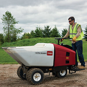 Ultra Buggy wheeled white male hauling concrete.