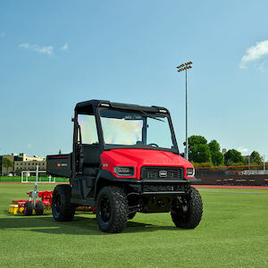 workman utx on a sports field pulling a bullseye field implement