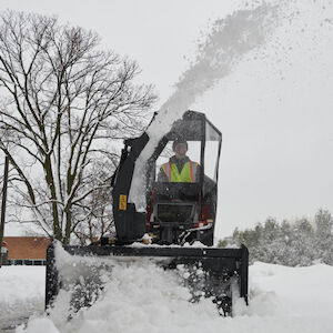 Dingo Snow Thrower Attachment - clearing snow off a street