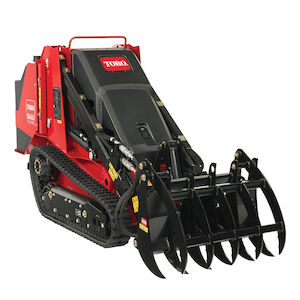 TX 700 narrow track loader left side with a grapple rake attachment