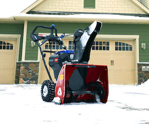 Image of Toro eSnowMaster snow blower in a snow cleared driveway
