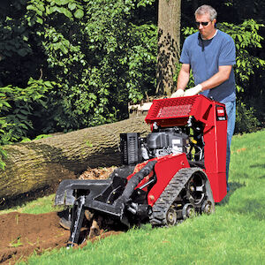 White male digging a trench with the TRX-16.