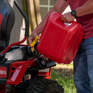 Close up of person filling the mower with gas