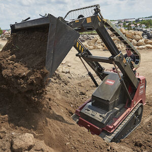 TXL2000 dumbing soil in pile with the bucket attachment