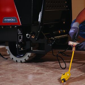 Electric Ultra Buggy plugging in the battery