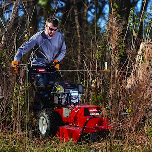 Brush cutter cutting through grass