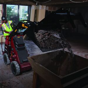 eDingo 500 dumping floor tile in a bucket