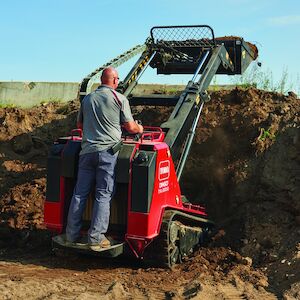 TXL2000 dumping dirt using the bucket attachment