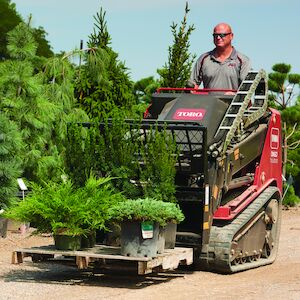 TXL2000 using the fork attachment carrying bushes on a pallet